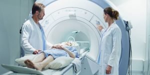 Doctors preparing a patient for MRI scan